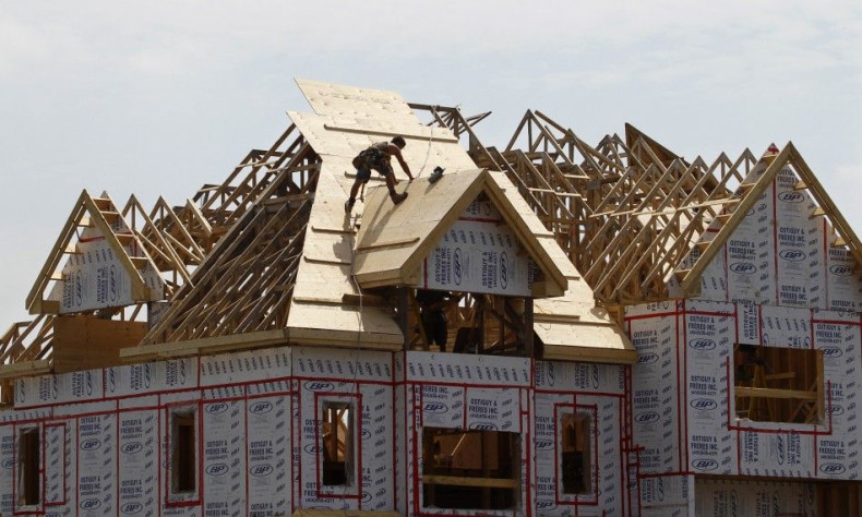 A builder works on the the roof of a new home under construction in the Montreal suburb of Brossard