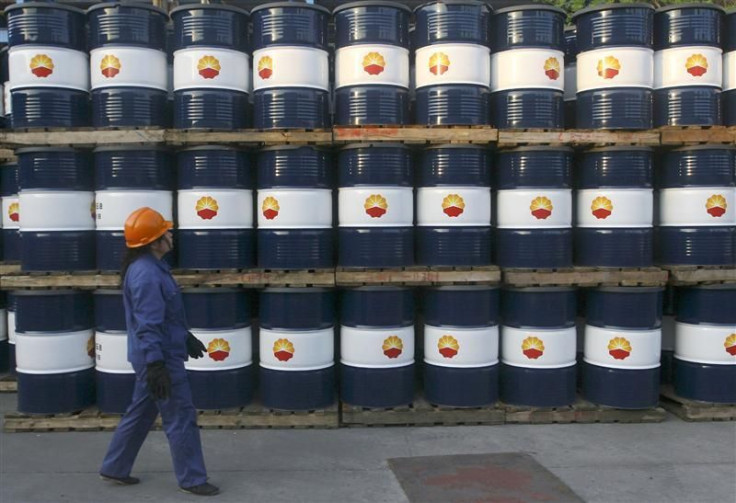 An engineer walks past piles of oil tanks at a PetroChina&#039;s oil refinery in Lanzhou