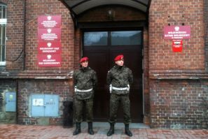 Military police stand guard outside military prosecutor&#039;s office in Poznan where military prosecutor Colonel Przybyl attempted suicide by shooting himself in head following news conference