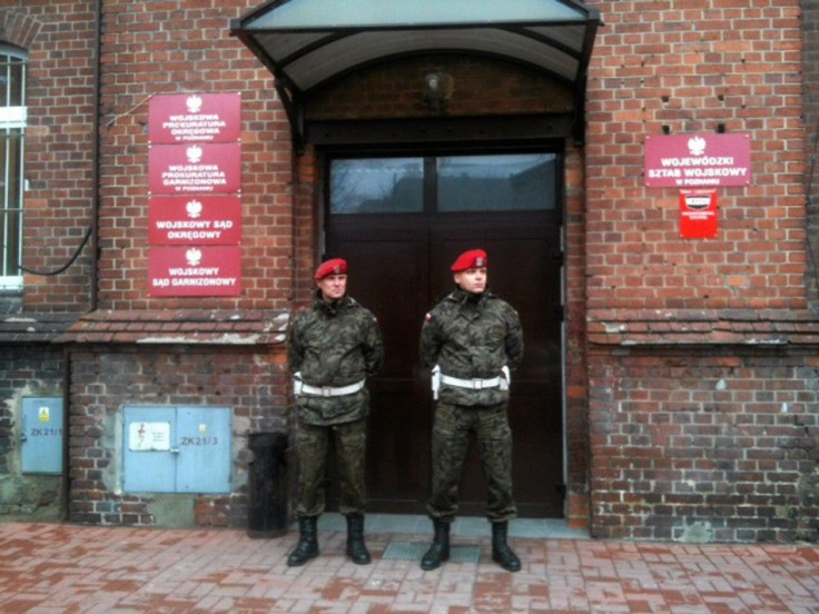 Military police stand guard outside military prosecutor&#039;s office in Poznan where military prosecutor Colonel Przybyl attempted suicide by shooting himself in head following news conference