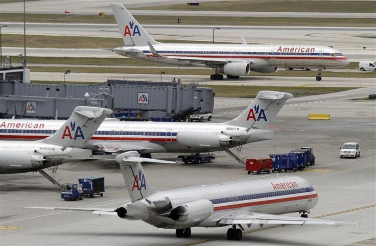American Airlines planes sit at their gates while others taxi for arrival and departure at O&#039;Hare International airport in Chicago