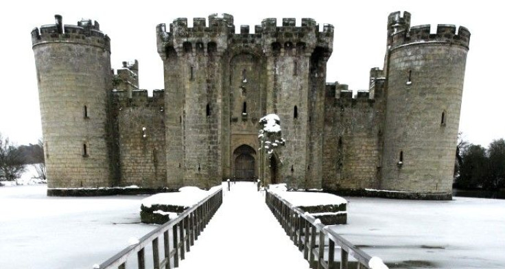 A snow covered gangway leads over a frozen moat to Bodiam Castle in southeast England. 