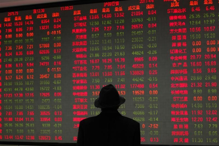 A man looks at an electronic board at a brokerage house in Shanghai