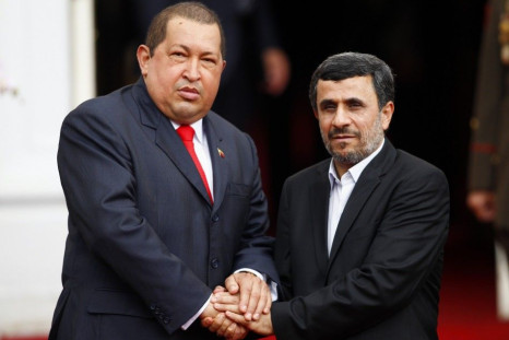 Iran&#039;s President Mahmoud Ahmadinejad and Venezuela&#039;s President Hugo Chavez shake hands during his welcoming ceremony at Miraflores Palace in Caracas