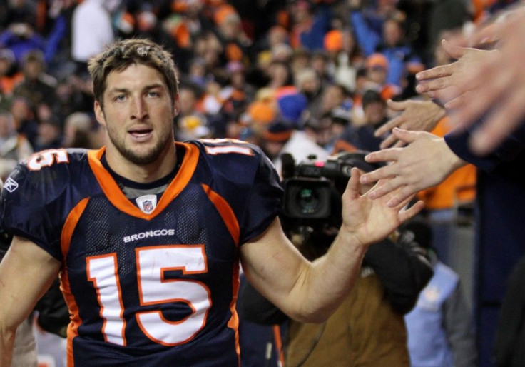 Denver Broncos quarterback Tim Tebow celebrates with fans after the Broncos defeated the Pittsburgh Steelers in overtime in the NFL AFC wildcard playoff football game in Denver