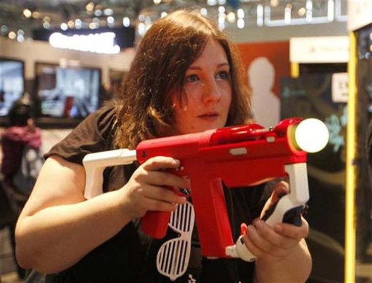 A visitor plays with a Playstation at the Sony Playstaytion exhibition stand during the Gamescom 2011 fair in Cologne