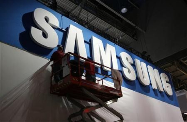 Workers prepare the booth for Samsung at the Consumer Electronics Show opening in Las Vegas