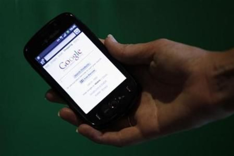 A T-Mobile employee holds a new android-based smartphone in London