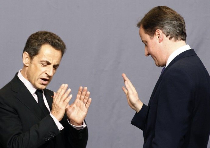 France's President Nicolas Sarkozy speaks with Britain's Prime Minister David Cameron at the NATO summit in Lisbon