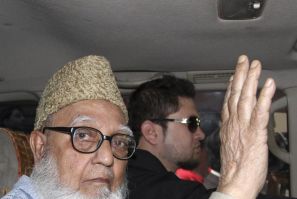 Ghulam Azam, former chief of Jamaat-e-Islami party, waves to the media after a court sent him to jail in Dhaka