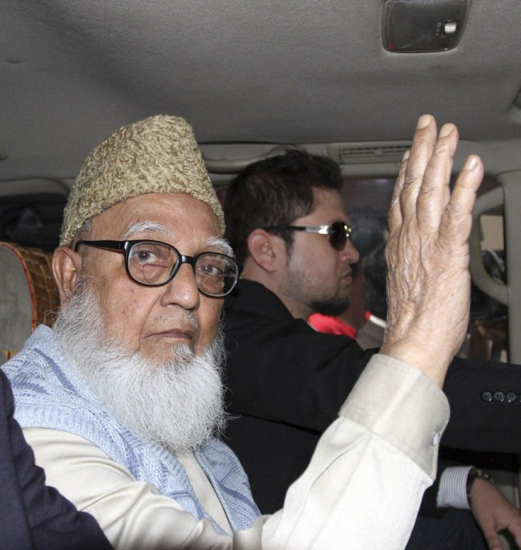 Ghulam Azam, former chief of Jamaat-e-Islami party, waves to the media after a court sent him to jail in Dhaka