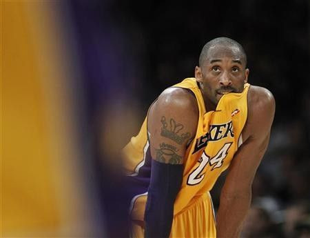 Los Angeles Lakers' Kobe Bryant looks on against the New York Knicks during second half of an NBA game in Los Angeles