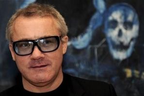 British artist Damien Hirst poses for photographers in front of his painting &#039;&#039;Shark&#039;s Jaw, Skull and Iguana on a Table&#039;&#039; (2008), in London
