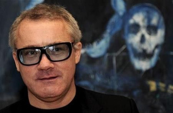 British artist Damien Hirst poses for photographers in front of his painting &#039;&#039;Shark&#039;s Jaw, Skull and Iguana on a Table&#039;&#039; (2008), in London