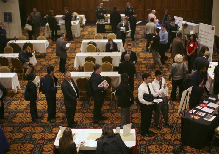 Job seekers stand in line to speak with employers at a job fair in San Francisco