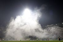 Heavy smoke caused by firecrackers is seen at the MSK Zilina stadium during the Champions League Group F soccer match between Zilina and Spartak Moscow in Zilina.