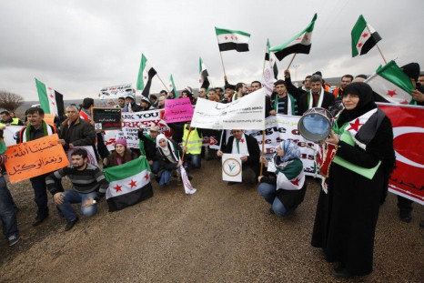 Activists of the Freedom Convoy wave independence flags during a gathering in the Turkish-Syrian border town of Kilis
