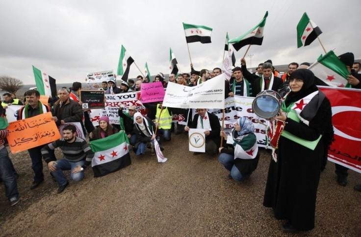 Activists of the Freedom Convoy wave independence flags during a gathering in the Turkish-Syrian border town of Kilis