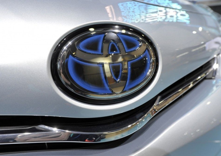 The Toyota logo is shown on the front of a Prius Hybrid vehicle during the first press preview day for the North American International Auto Show in Detroit