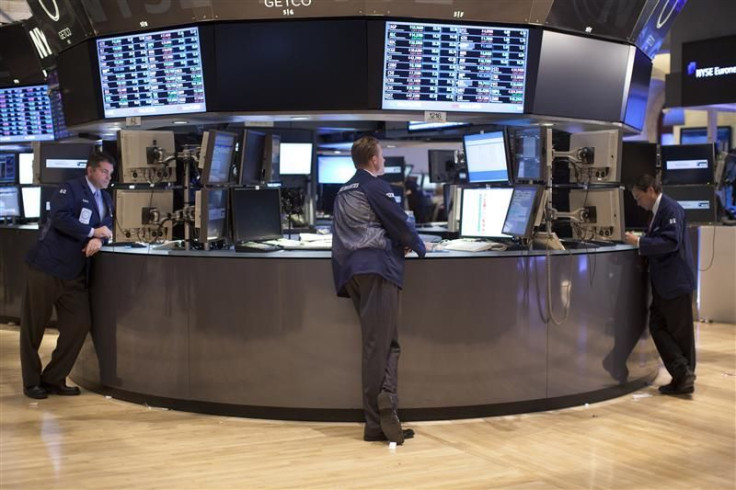 Traders work on the floor of the New York Stock Exchange at the end of the trading day in New York