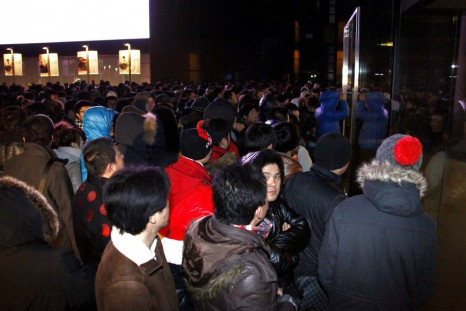 A crowd stands outside an Apple store in Beijing