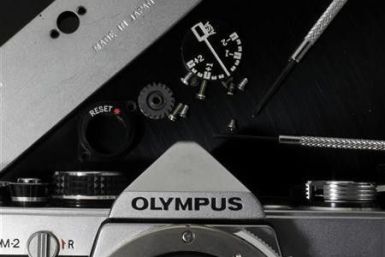 A disassembled Olympus camera and its parts are seen in this illustrative photograph taken in Tokyo, November 24, 2011.