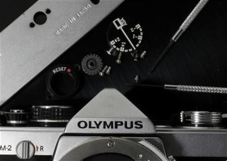A disassembled Olympus camera and its parts are seen in this illustrative photograph taken in Tokyo, November 24, 2011.