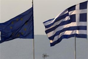 A Greek and an EU flag fly over the Greece's Finance Ministry in Athens