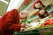 Elderly German Christine Evelt, 78, who is visually impaired, shops for groceries at her local store in the northern town of Greven 