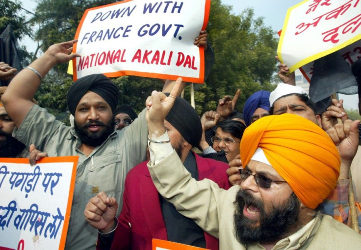 Members of National Akali Dal, a regional Sikh political party, shout anti-French slogans during a protest in New Delhi