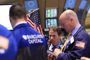 Traders work on the floor of the New York Stock Exchange, January 13, 2012.