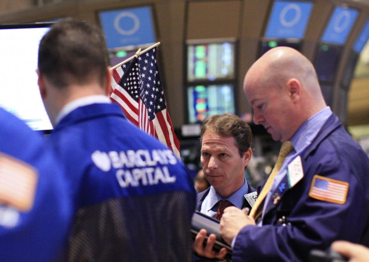 Traders work on the floor of the New York Stock Exchange, January 13, 2012.