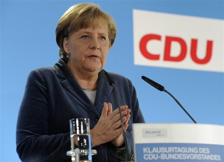 German Chancellor and leader of the Christian Democratic Party (CDU) Merkel gestures as she addresses the media during a party convention in Kiel.