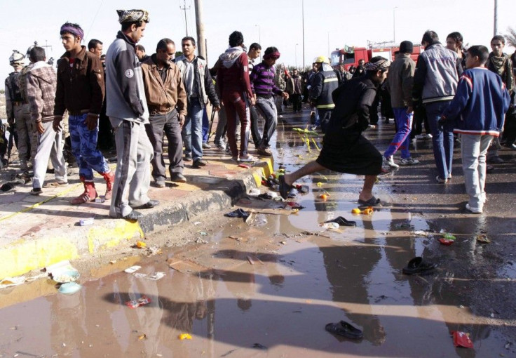 Residents inspect the site of a bomb attack in Basra