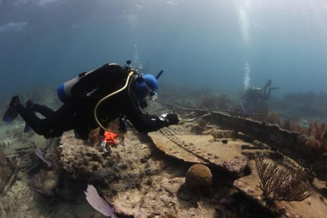 Divers examine a 1911 shipwreck off Key Largo