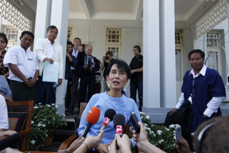 Myanmar's pro-democracy leader Aung San Suu Kyi talks to reporters after meeting France's Foreign Minister Alain Juppe in her home in Yangon January 15, 2012.