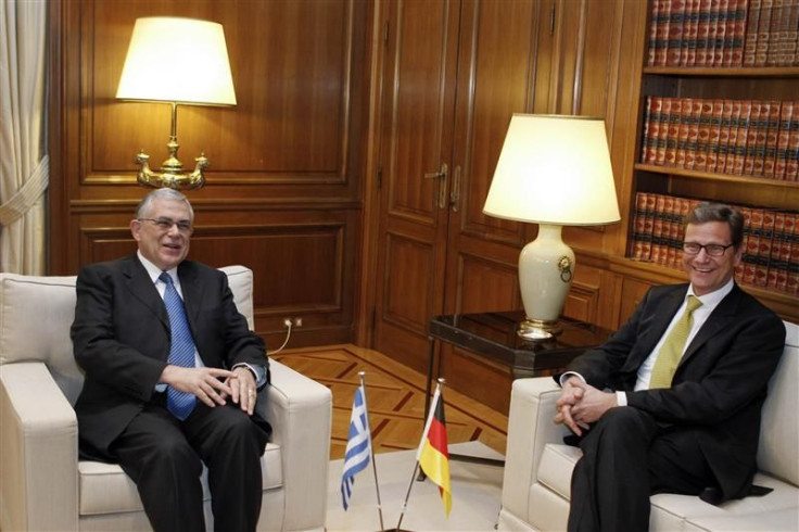 German Foreign Minister Westerwelle talks with Greek Prime Minister Papademos during their meeting in Athens