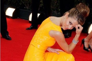 Actress Maria Menounos strikes a pose like American football player Tim Tebow at the 69th annual Golden Globe Awards in Beverly Hills 