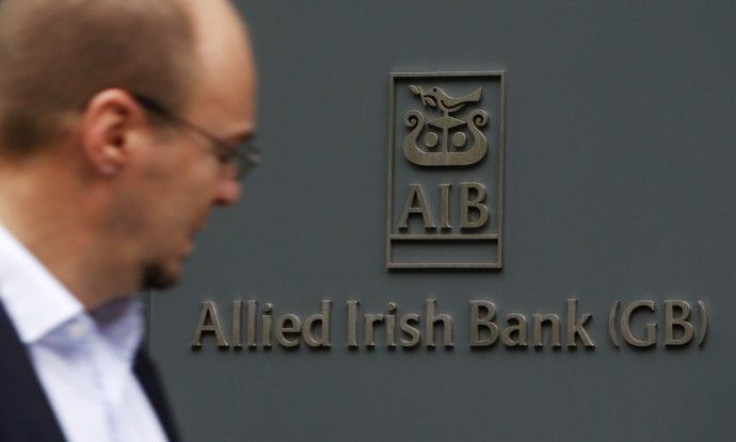A pedestrian passes a branch of Allied Irish Bank in London
