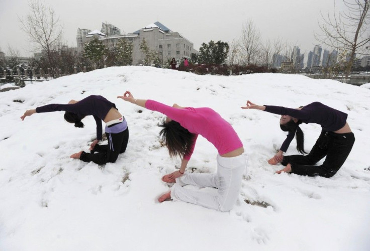 Local residents practise yoga after a snowfall at a park in Wuhan, Hubei province January 6, 2010.