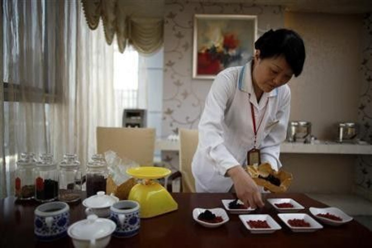 An employee prepares food for mothers using traditional Chinese medicine at the CareBay maternity care centre in Shanghai December 23, 2011.