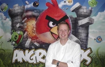 Rovio Chief Executive Mikael Hed stands in front of an Angry Birds poster at his companys offices in Helsinki