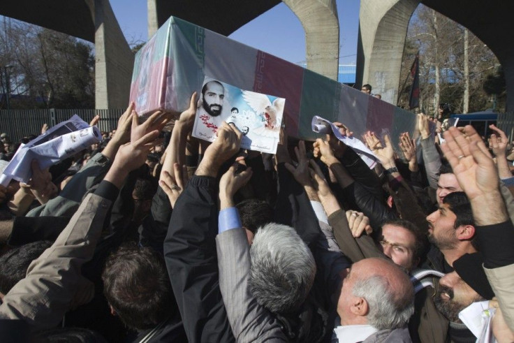 Iranian worshippers carry a picture and coffin of Mostafa Ahmadi-Roshan during his funeral after Friday prayers in Tehran