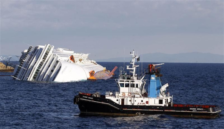 A boat with rescue workers is seen near the Costa Concordia cruise ship that ran aground off the west coast of Italy, at Giglio island
