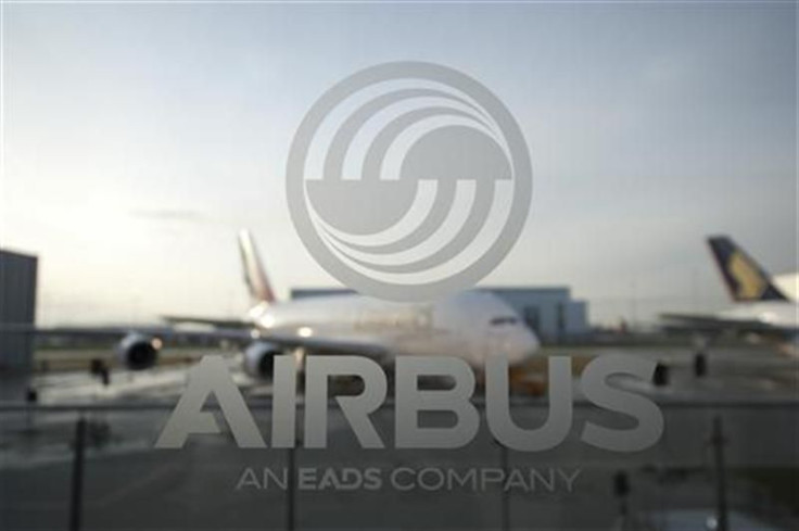 An A380 aircraft is seen through a window with an Airbus logo during the EADS / Airbus &#039;New Year Press Conference&#039; in Hamburg