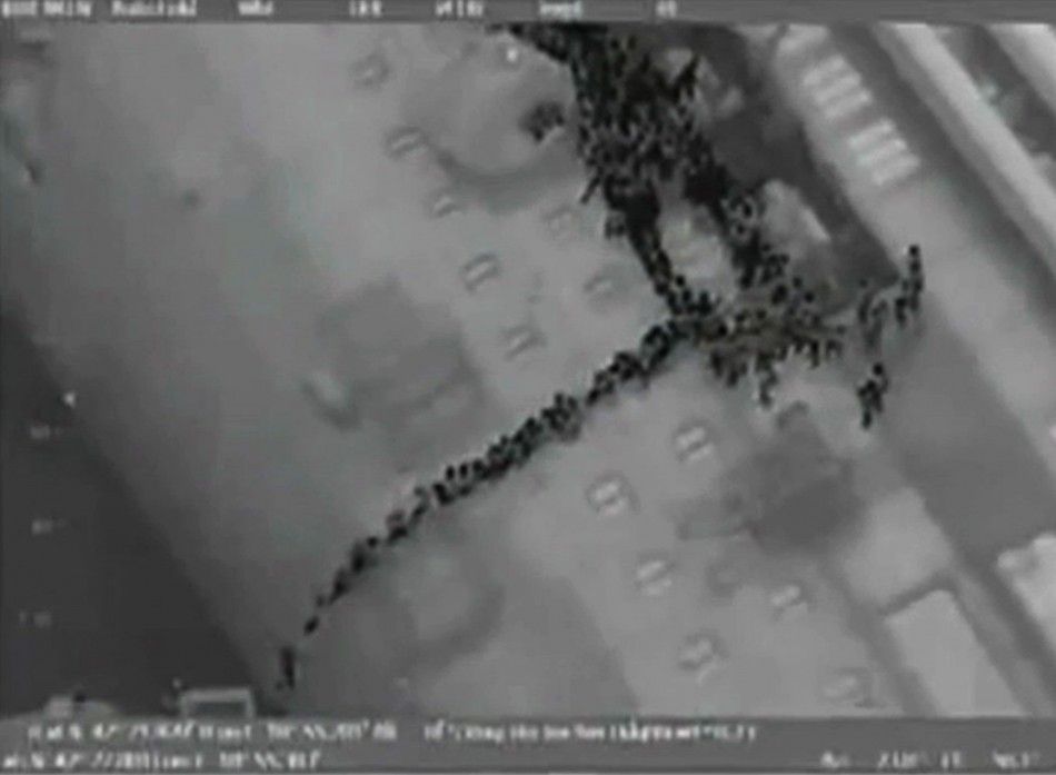 Video grab shows passengers lined up on the side of the Costa Concordia during the evacuation operation
