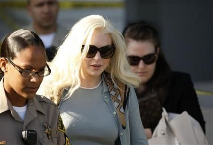 Actress Lindsay Lohan leaves the court after a progress report hearing in Los Angeles, California