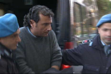 Captain Francesco Schettino of cruise ship Costa Concordia is escorted into a prison by police officers at Grosseto