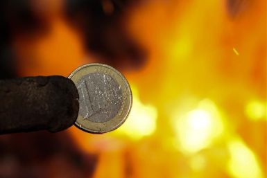 An illustration picture shows a one Euro coin being melted by a smith in Skopje