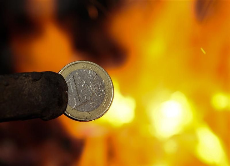 An illustration picture shows a one Euro coin being melted by a smith in Skopje